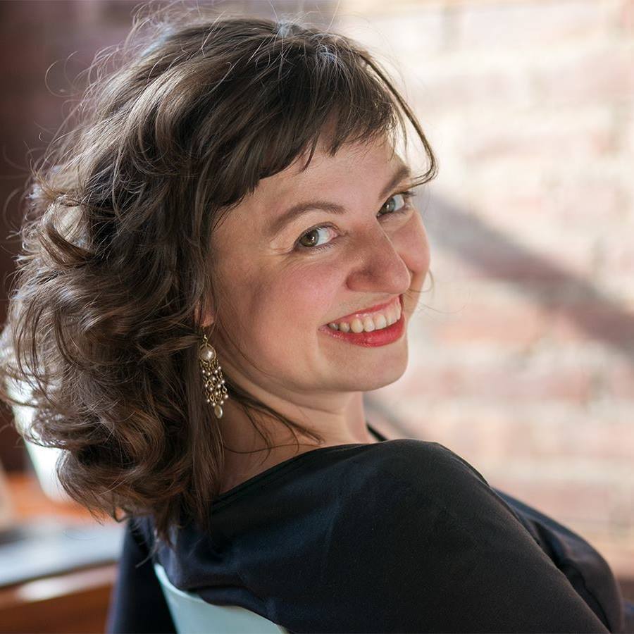 Portrait of Victoria Bulgakova looking over shoulder, smiling